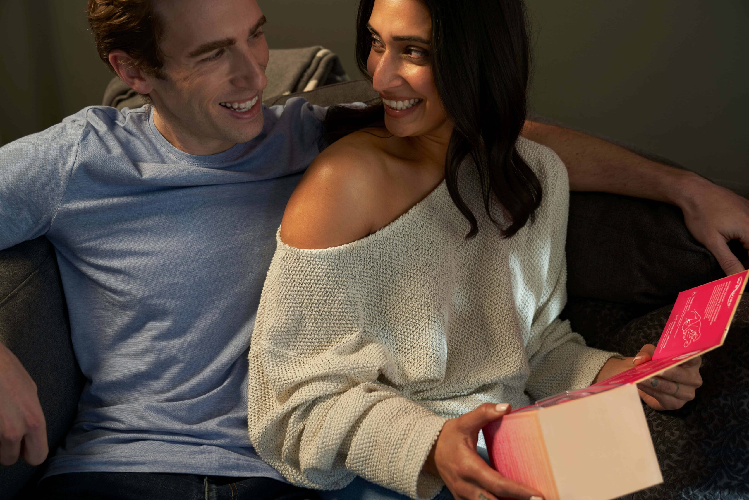 couple laughing on couch